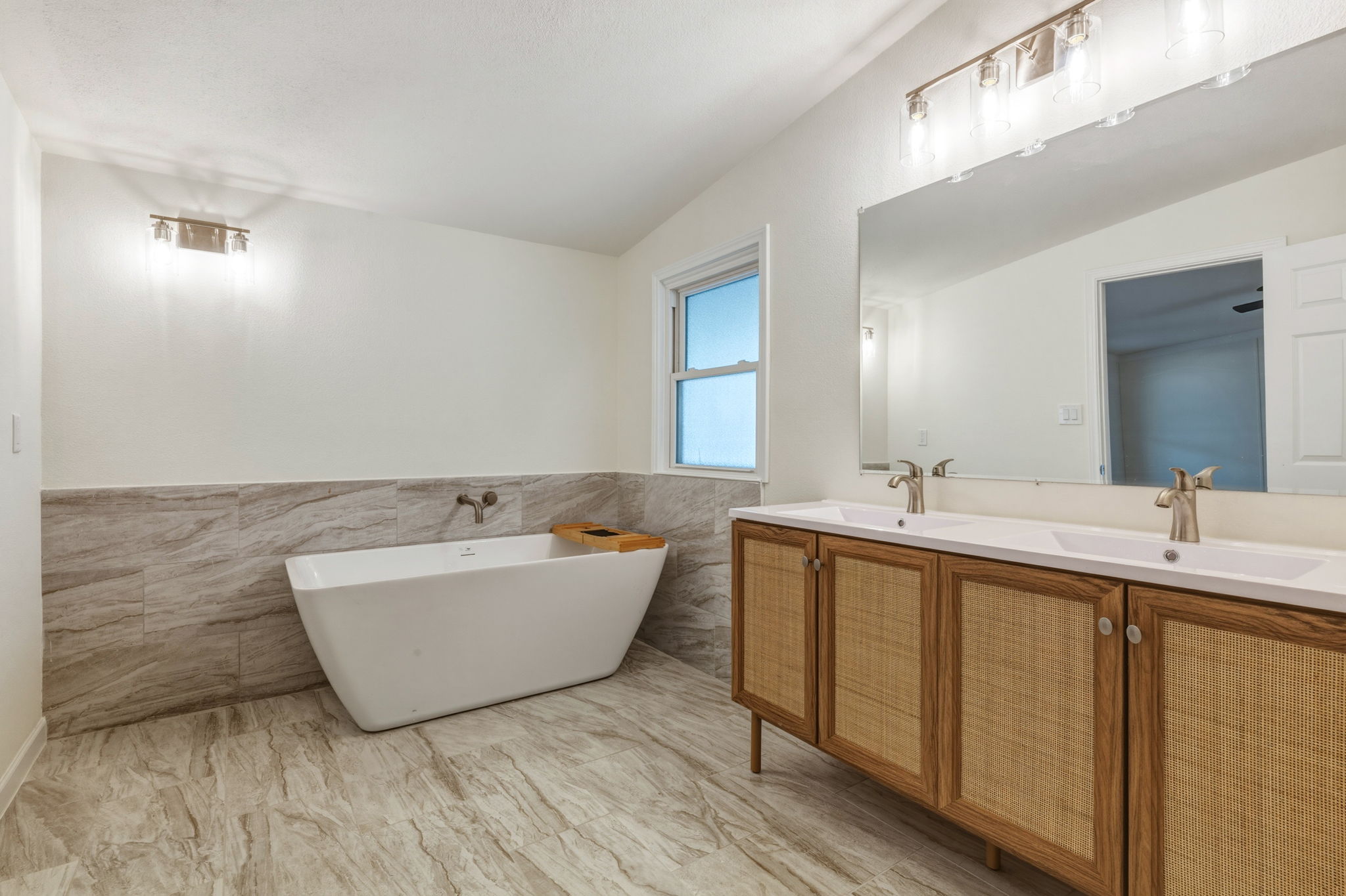 340 Red Hawk Drive Dale, TX 78616 - Photo 19 of 39 Full bathroom with double vanity, tile walls, and a soaking tub