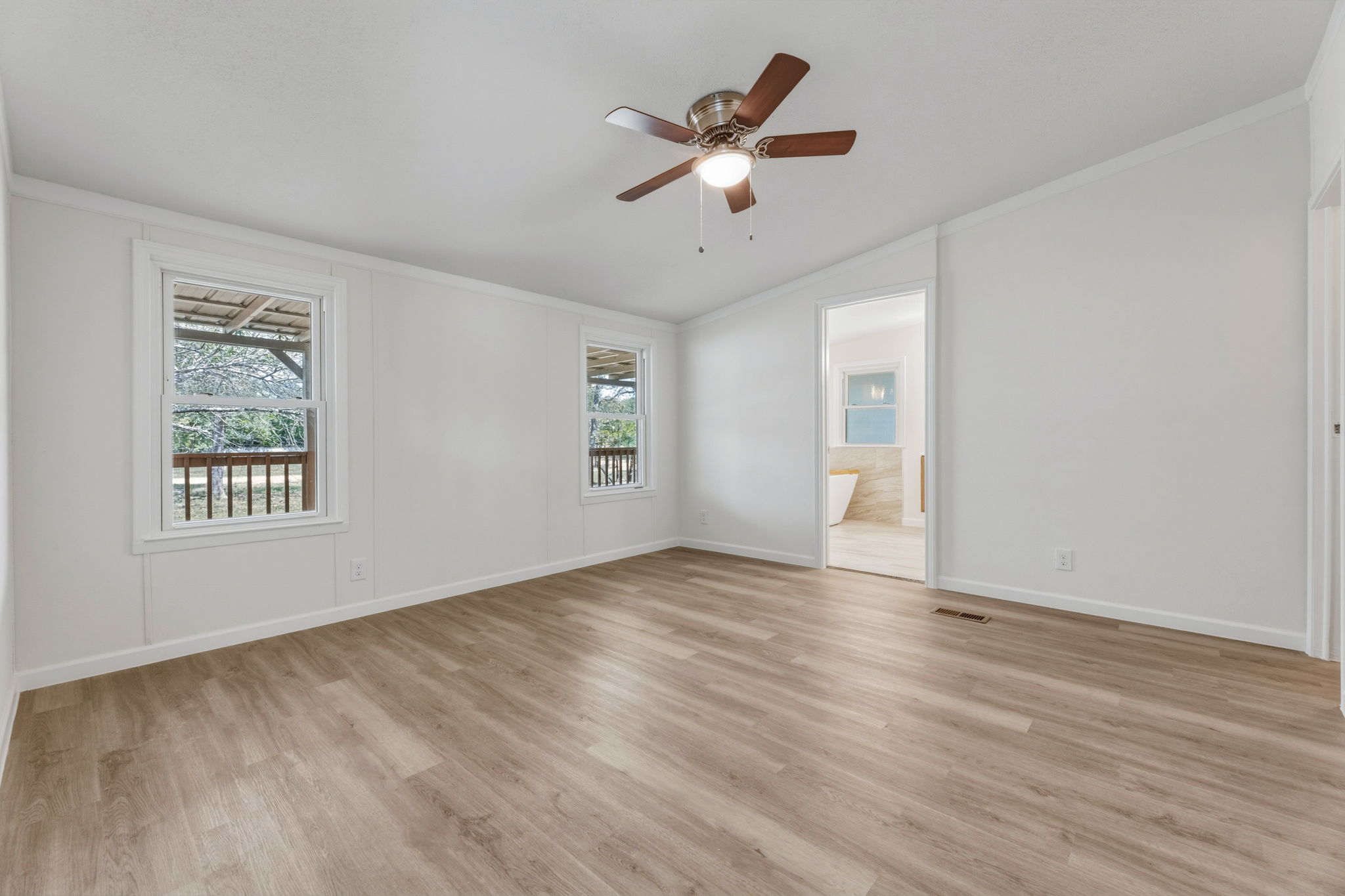 340 Red Hawk Drive Dale, TX 78616 - Photo 22 of 38 Primary Bedroom with ensuite bathroom and a ceiling fan