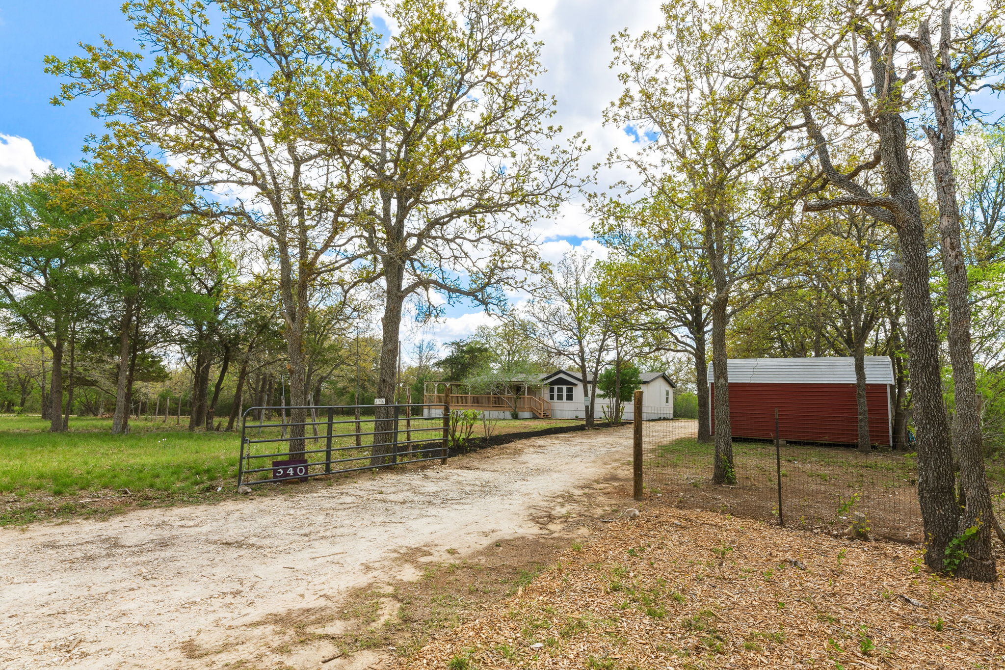 340 Red Hawk Drive Dale, TX 78616 - Photo 7 of 38 View of dirt / gravel road with a gate and a gated entry