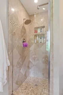 a bathroom with a granite countertop sink toilet and mirror