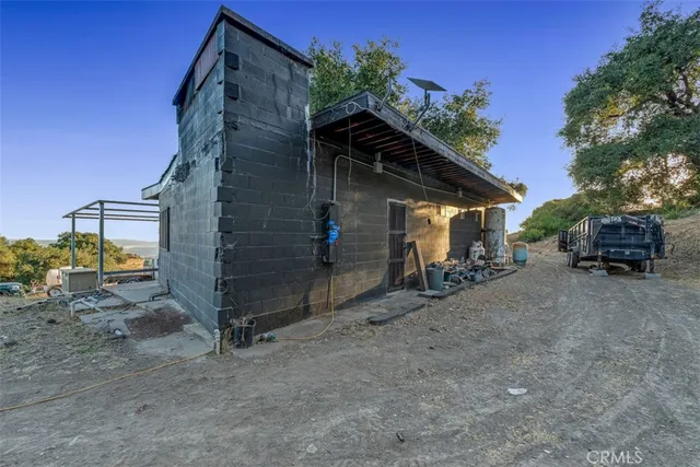 a view of a field with trees in the background