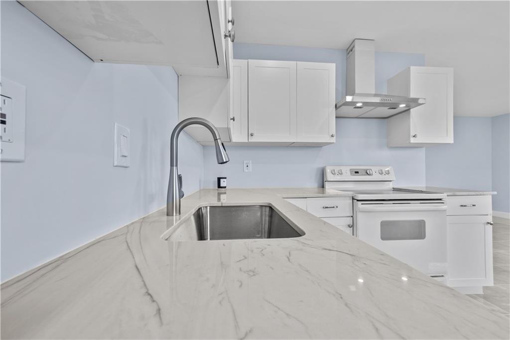 260 Northwest 19th Street, Unit 290 Boca Raton, FL 33432 - Photo 7 of 18 a kitchen with stainless steel appliances granite countertop a sink a stove and cabinets