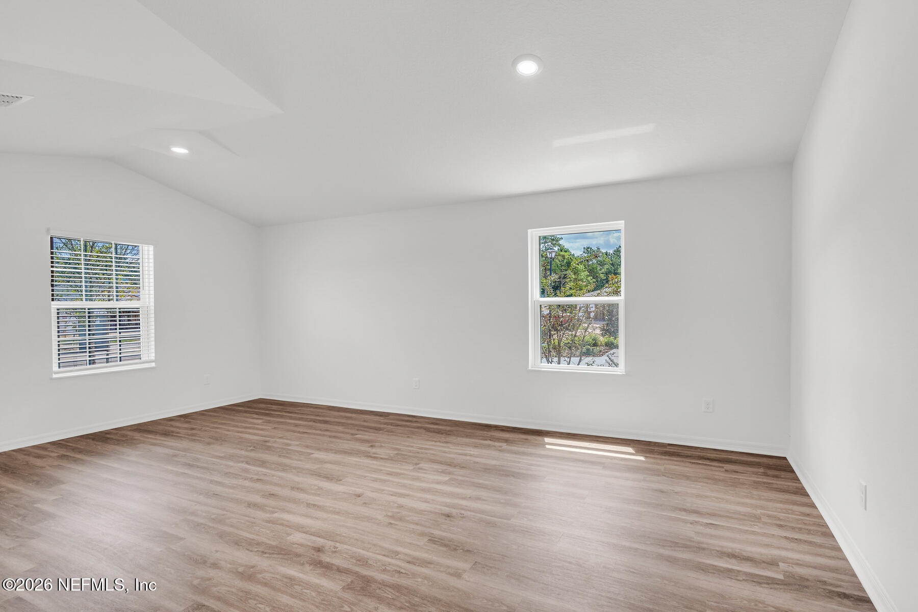 6967 Canoe Birch Road Jacksonville, FL 32219 - Photo 4 of 20 a view of an empty room with wooden floor and a window