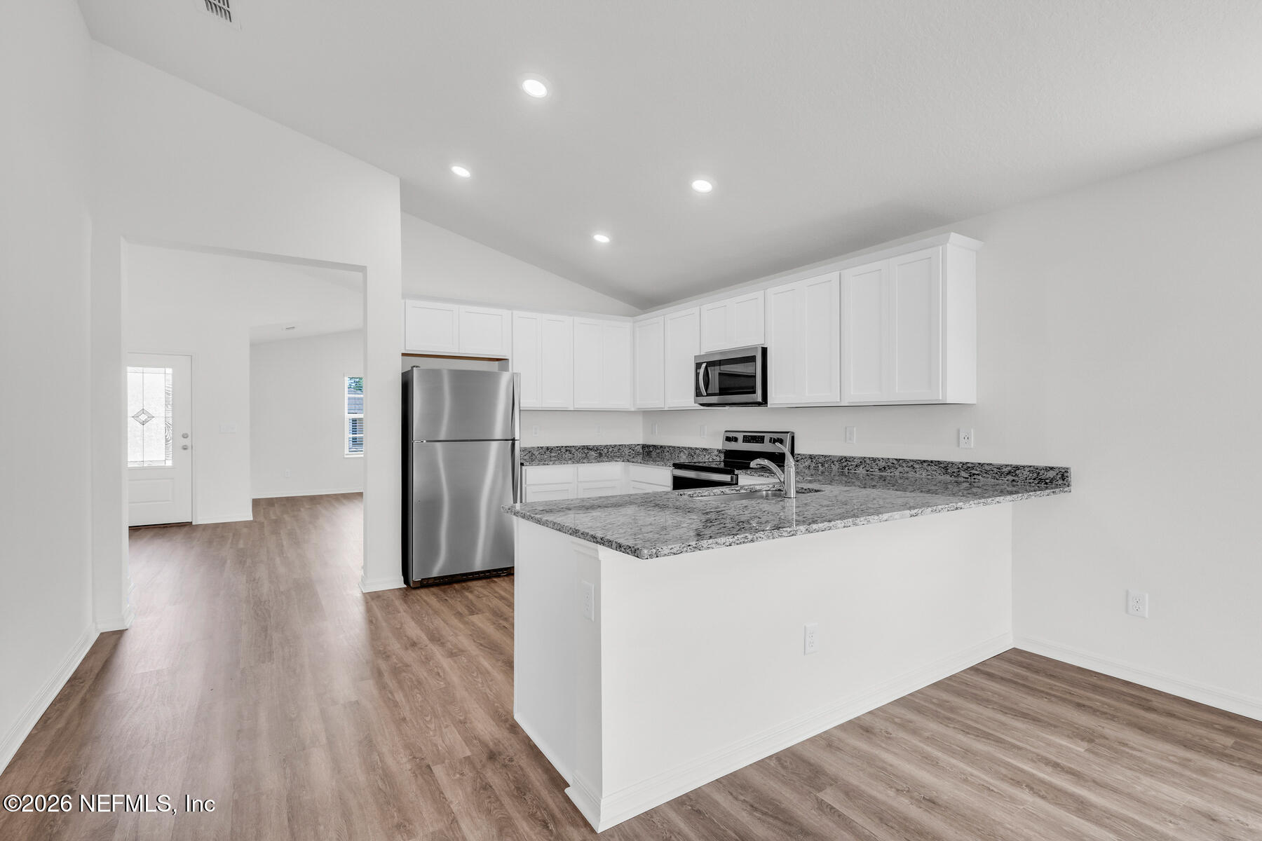 6967 Canoe Birch Road Jacksonville, FL 32219 - Photo 7 of 20 a kitchen with stainless steel appliances granite countertop a refrigerator and a stove top oven