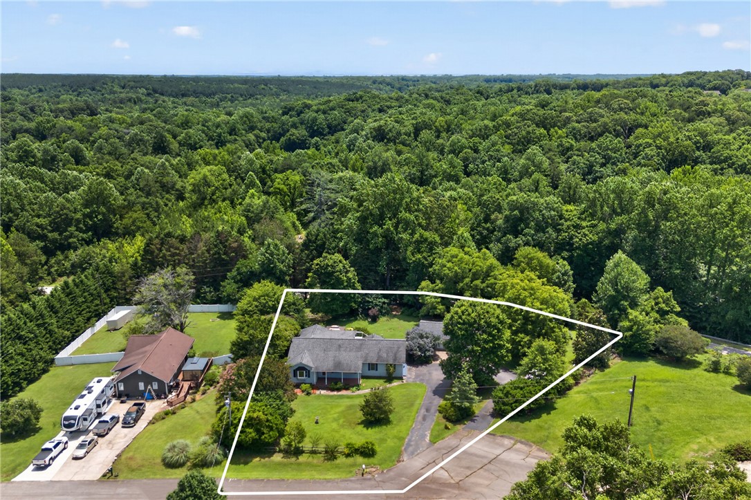 103 Dorsey Lane Walhalla, SC 29691 - Photo 39 of 42 An aerial perspective reveals a charming dwelling nestled amidst a lush, verdant landscape, featuring a paved driveway.