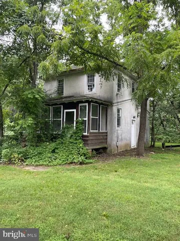 a house that has a tree in front of the house