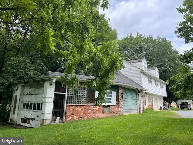 a view of a house with a yard and sitting area