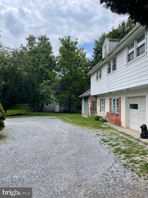 323 East Street Road Kennett Square, PA 19348 - Photo 6 of 6 a front view of a house with a yard and trees