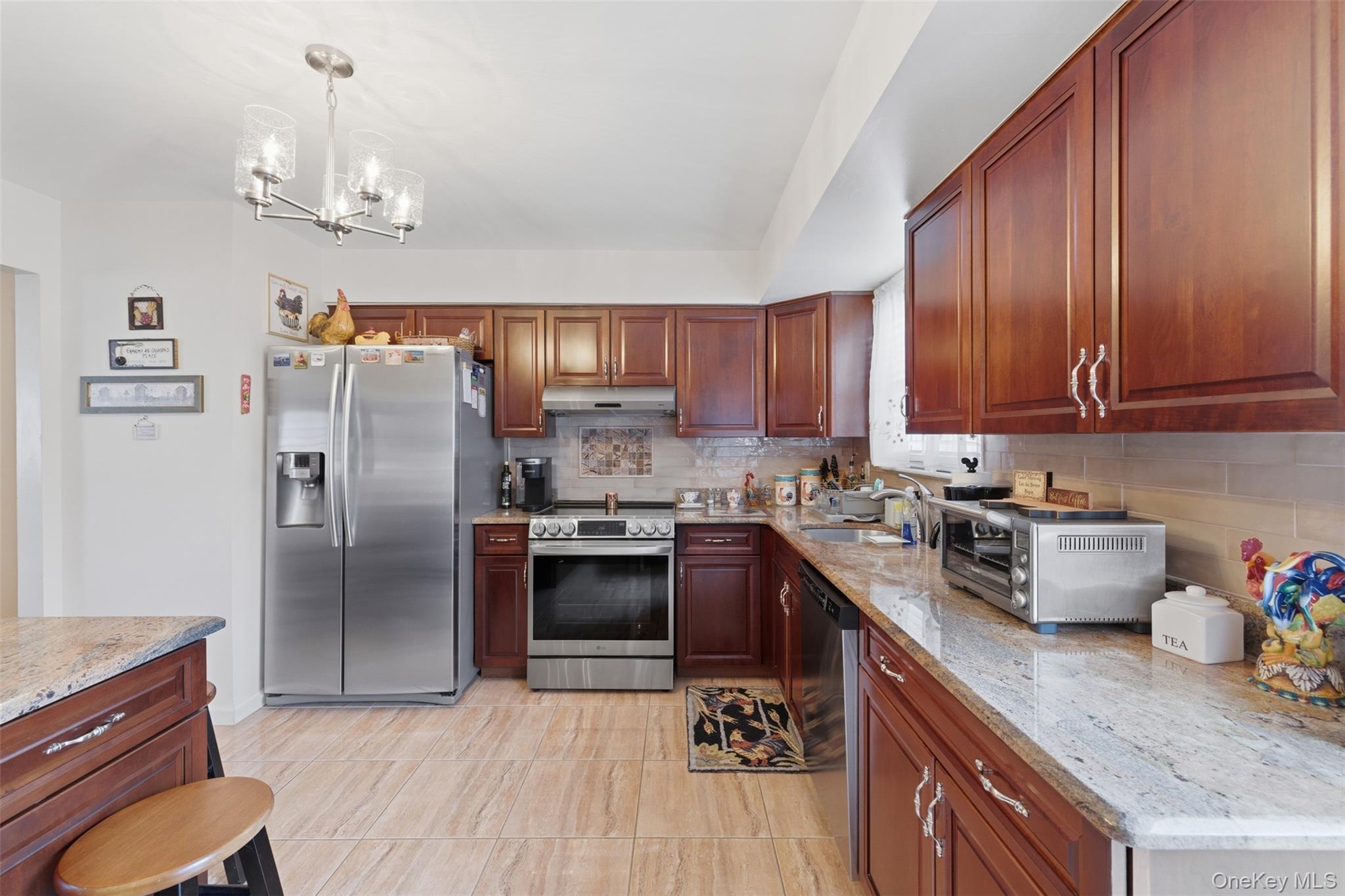 1 Weather Vane Way Middletown, NY 10940 - Photo 13 of 41 a kitchen with granite countertop stainless steel appliances a sink dishwasher a refrigerator a stove top oven a large island with wooden floor and cabinets