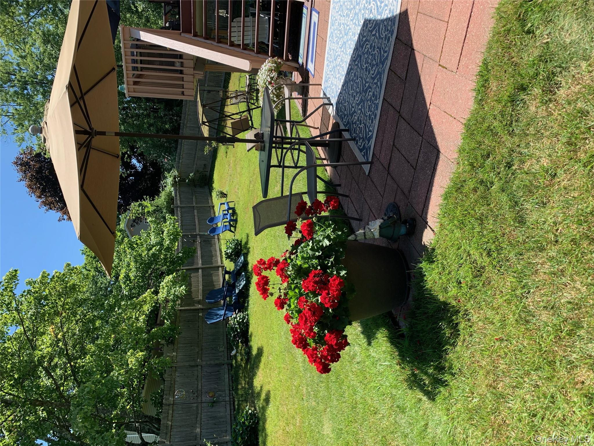 1 Weather Vane Way Middletown, NY 10940 - Photo 32 of 41 a view of garden with sitting area and an umbrella