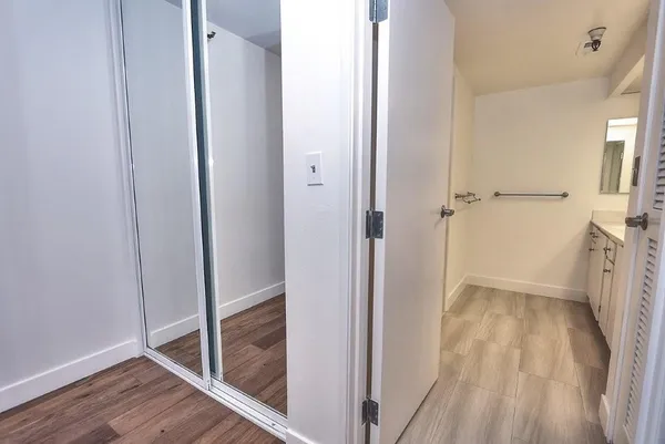 a spacious bathroom with a double vanity sink and mirror