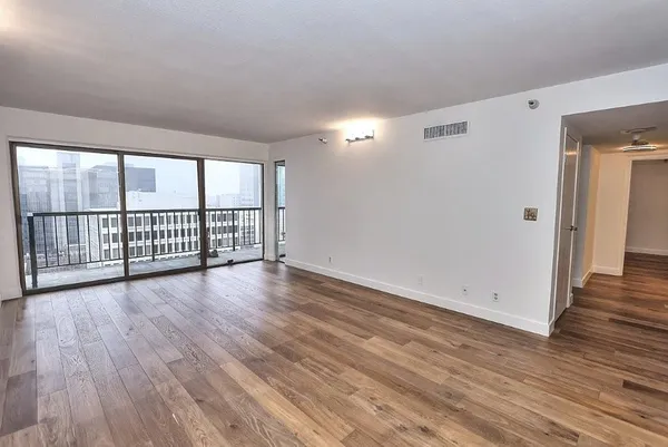 wooden floor in an empty room with a window