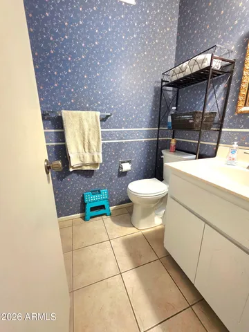a bathroom with a toilet a sink and a mirror