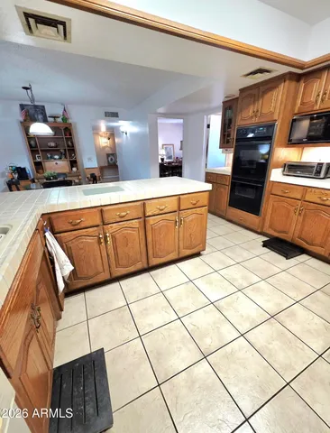 a kitchen with stainless steel appliances a stove a sink and a refrigerator