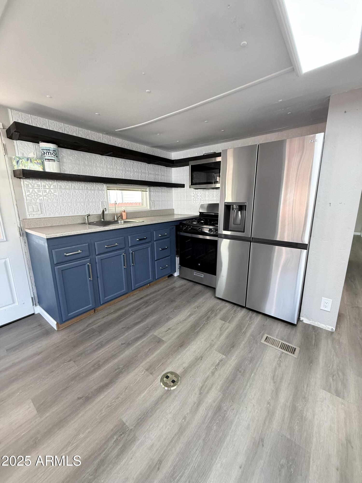 960 Peace Lane, Unit 77 Prescott, AZ 86305 - Photo 23 of 27 a kitchen with stainless steel appliances granite countertop a refrigerator a sink and a stove