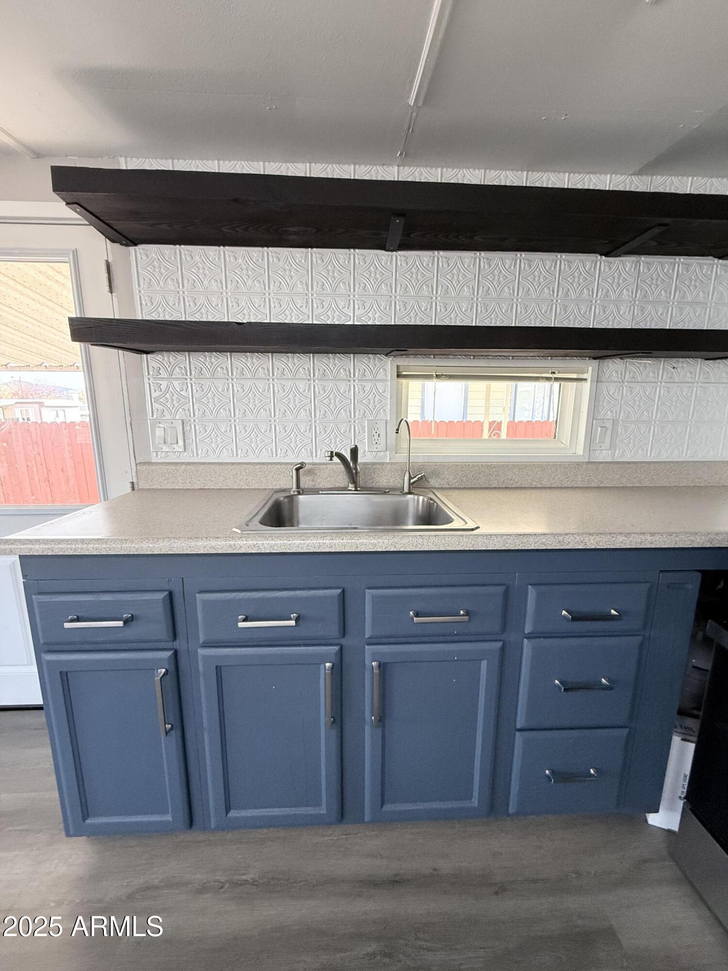 960 Peace Lane, Unit 77 Prescott, AZ 86305 - Photo 24 of 27 a kitchen with stainless steel appliances granite countertop wooden cabinets and sink