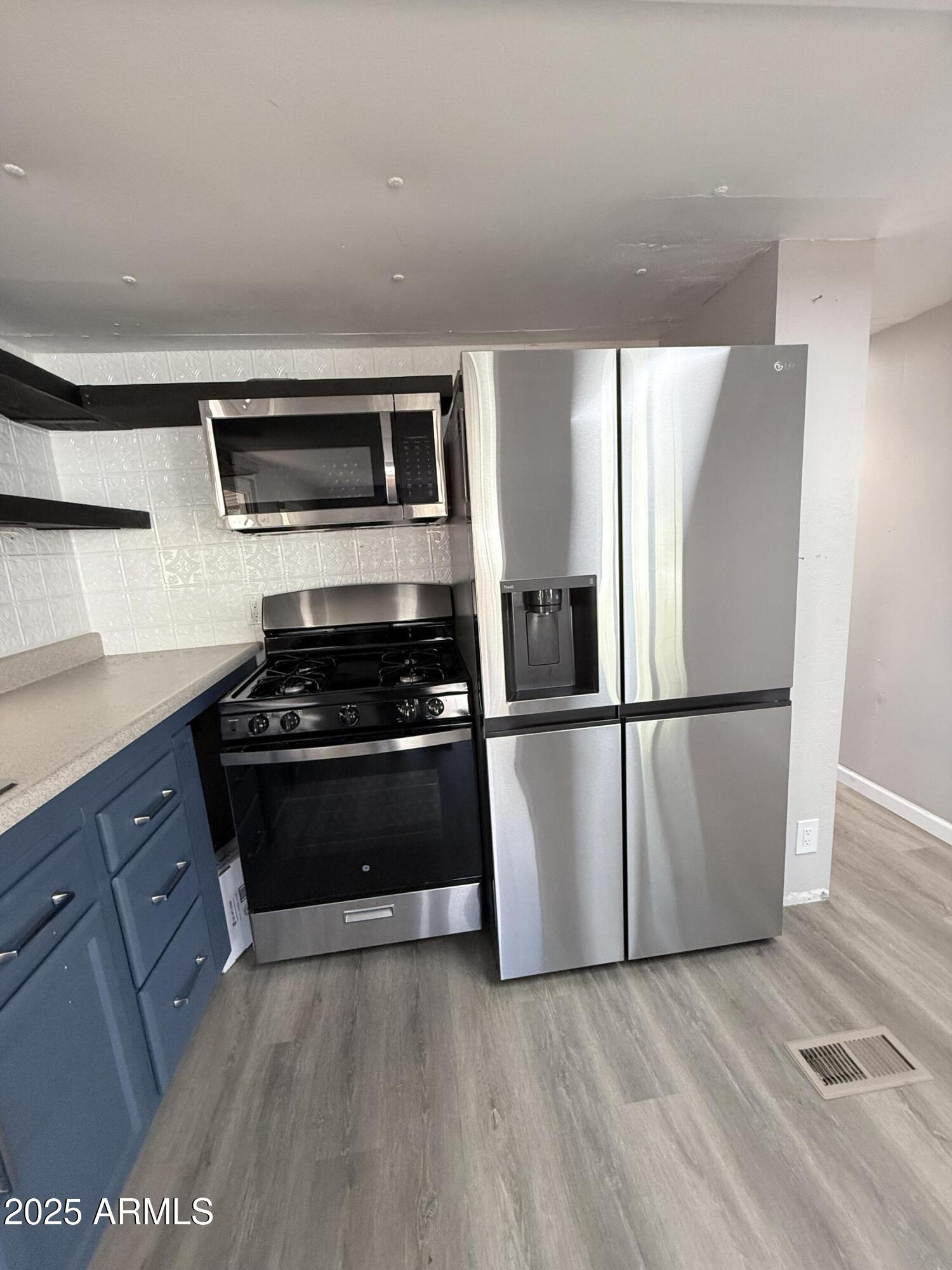 960 Peace Lane, Unit 77 Prescott, AZ 86305 - Photo 25 of 27 a kitchen with stainless steel appliances a refrigerator stove and microwave
