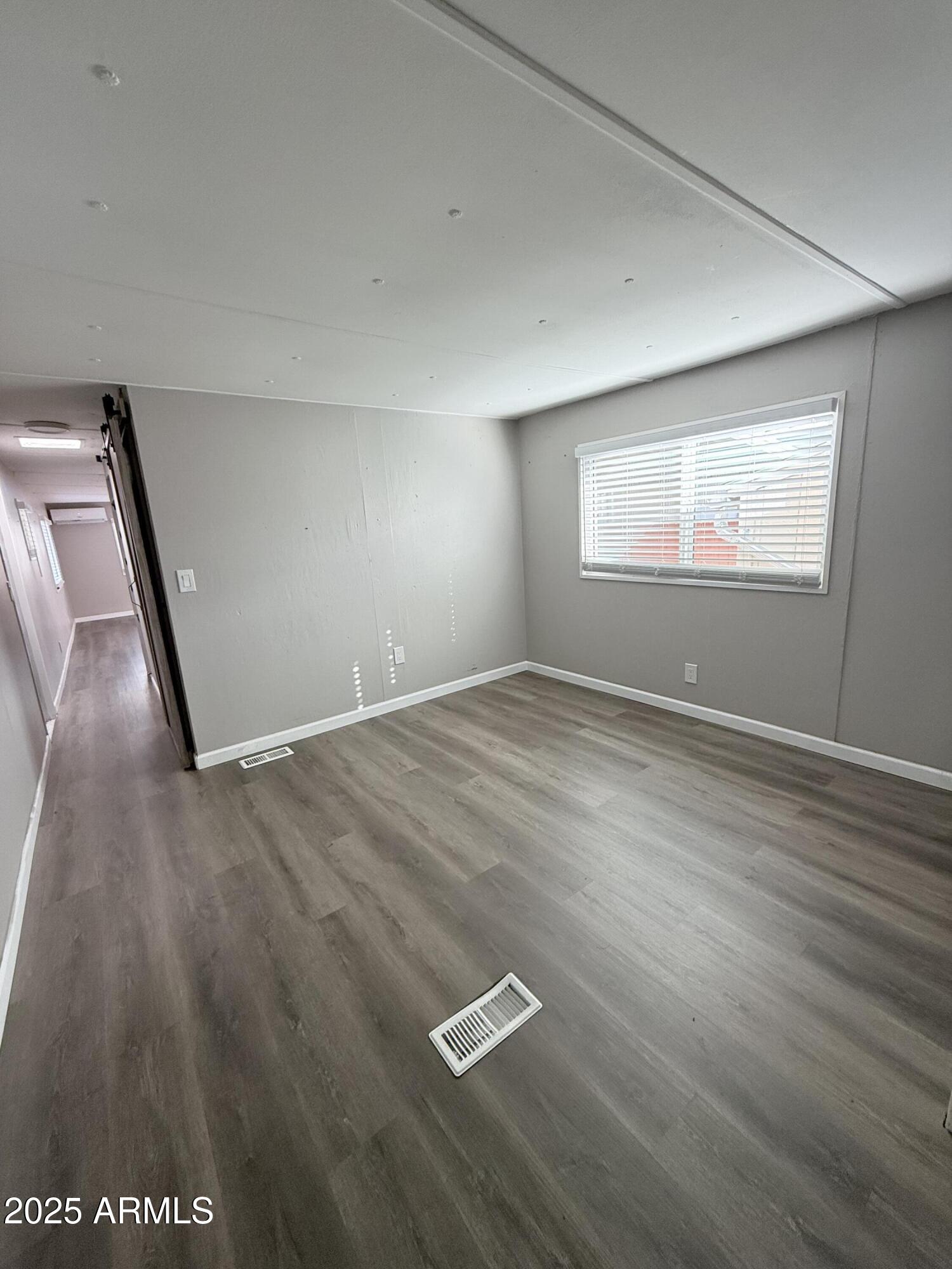 960 Peace Lane, Unit 77 Prescott, AZ 86305 - Photo 6 of 27 an empty room with wooden floor and windows
