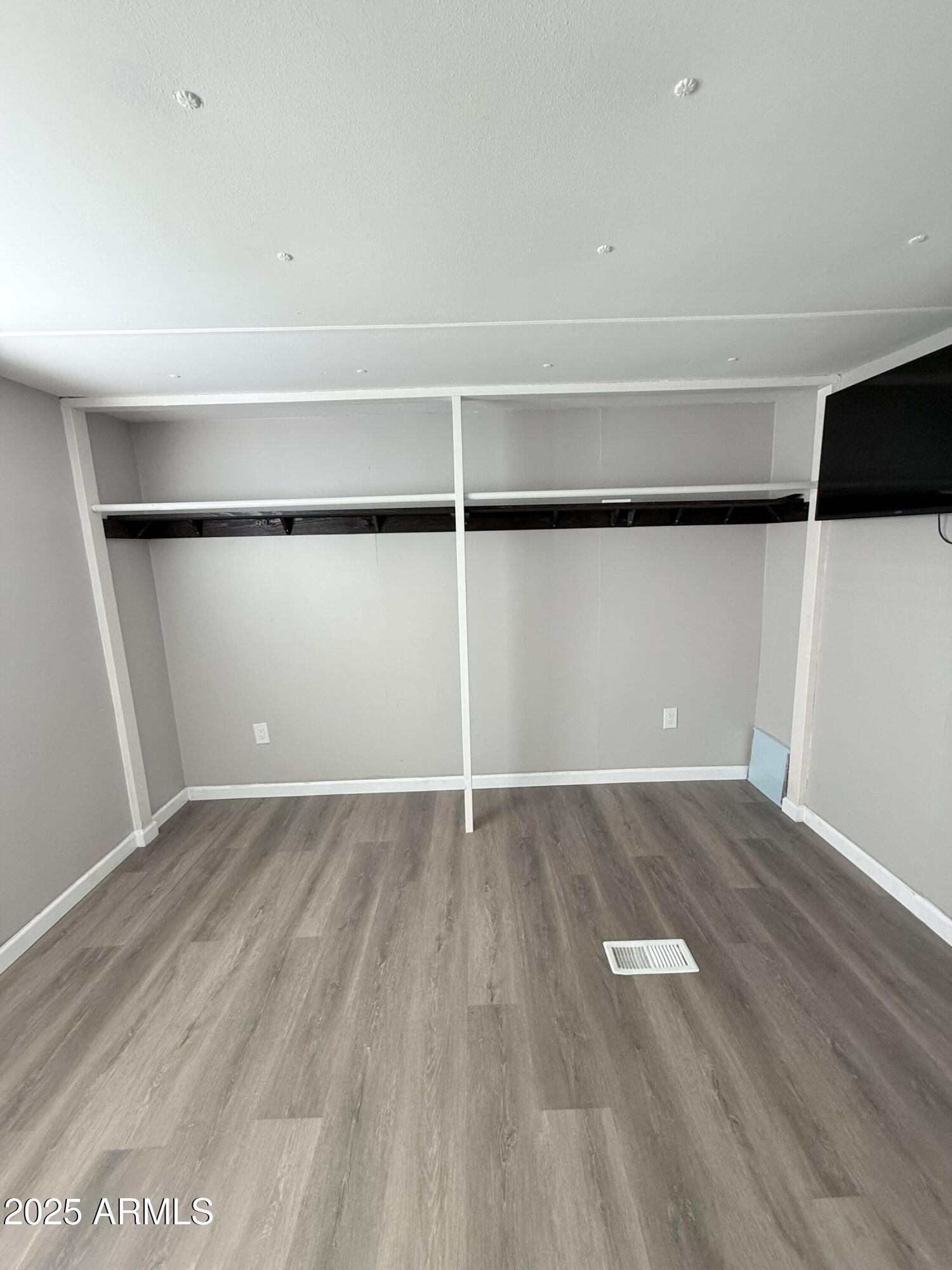 960 Peace Lane, Unit 77 Prescott, AZ 86305 - Photo 7 of 27 an empty room with wooden floor and windows