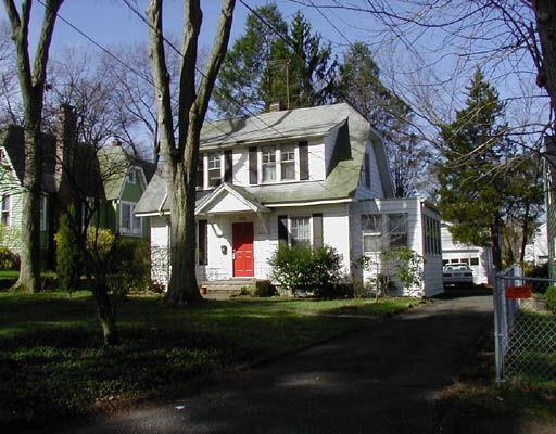 116 Spring Hill Avenue Norwalk, CT 06850 - Photo 1 of 1 a front view of a house with a garden and plants