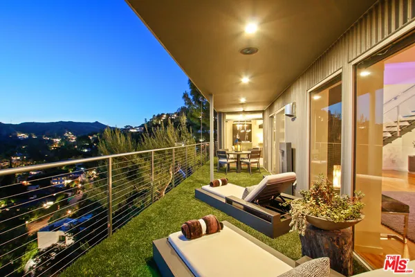 swimming pool with outdoor seating and green space