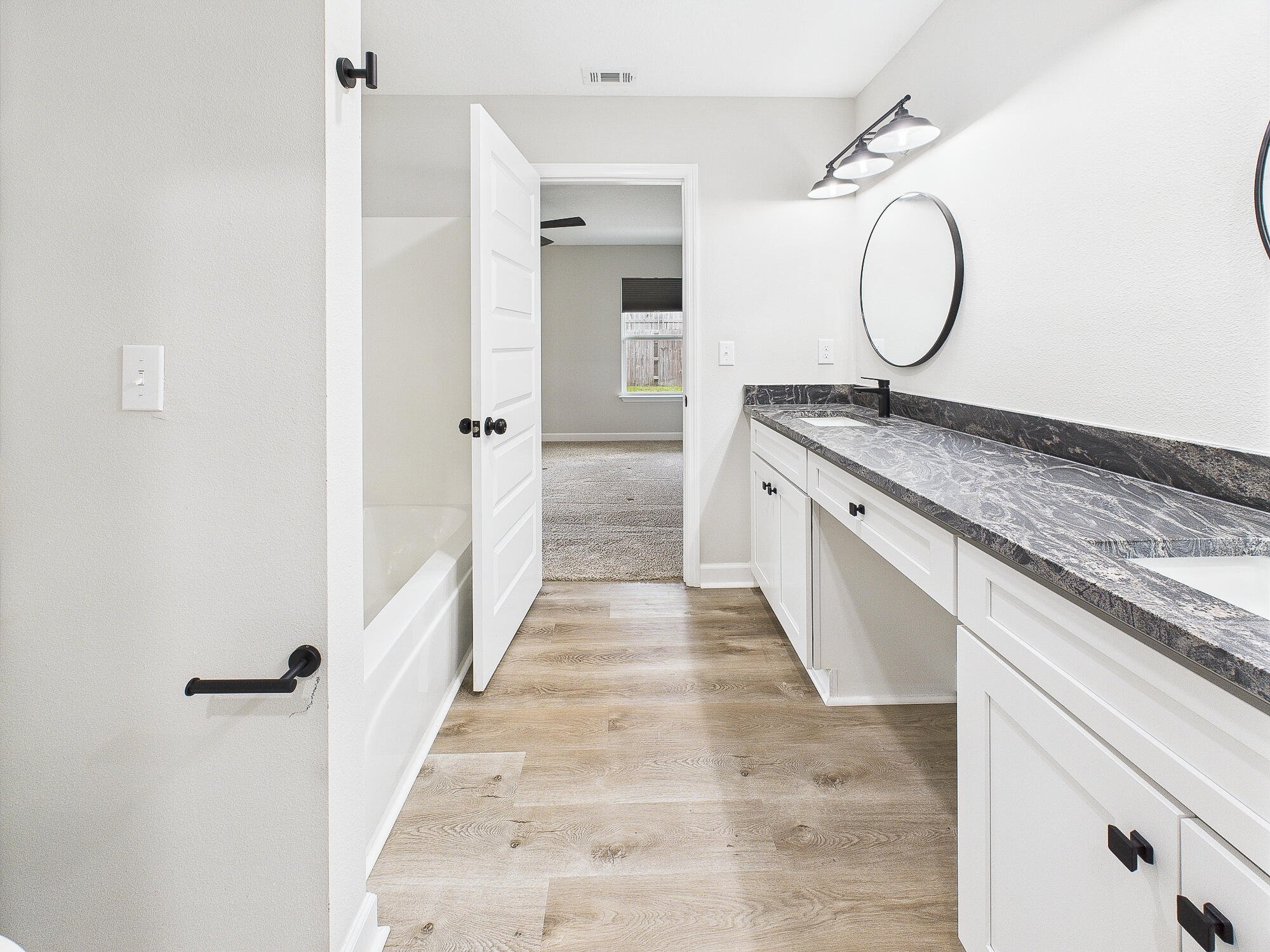 5117 Colt Drive Crestview, FL 32539 - Photo 17 of 32 a bathroom with a granite countertop double vanity sink and a mirror