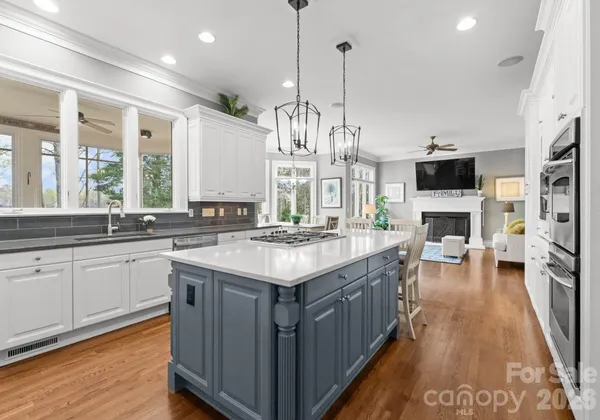 a kitchen with stainless steel appliances granite countertop a stove and cabinets