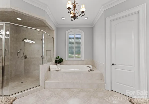 a spacious bathroom with a bathtub and a shower