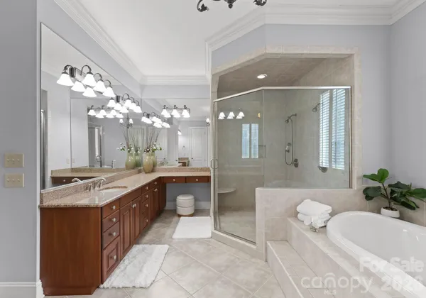 a spacious bathroom with a granite countertop sink a mirror and a bathtub