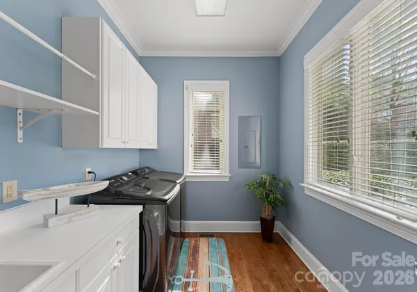 a kitchen that has a sink stove and cabinets