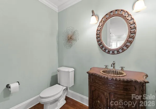a bathroom with a toilet a sink and a mirror