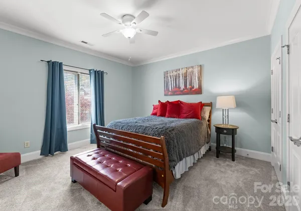 a bedroom with a bed dresser and a window