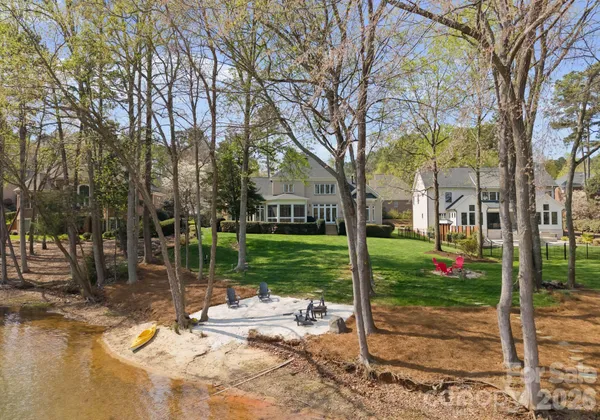 a view of a house with backyard and a tree