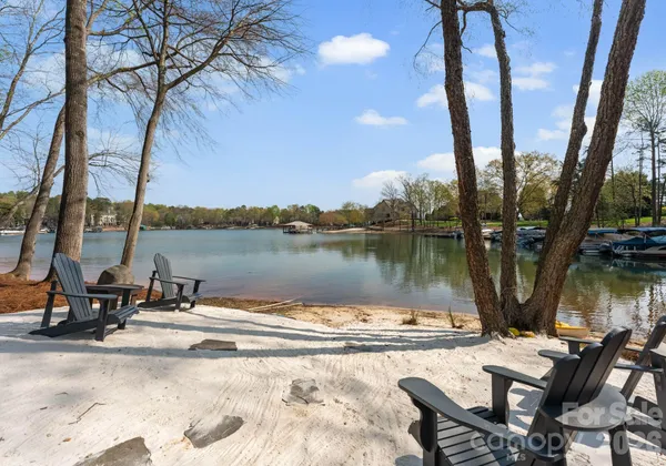 a view of a lake with a table and chairs