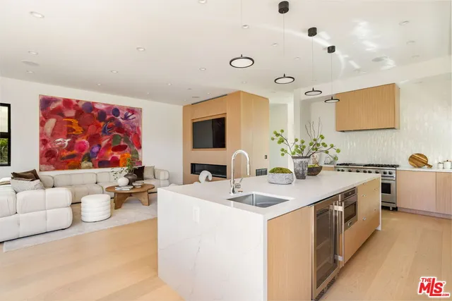 a large white room with a large mirror and sink