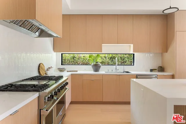 a kitchen with a stove a sink and a microwave