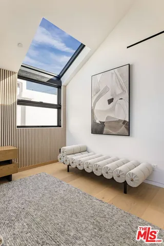 a bathroom with a tub a sink and a large mirror