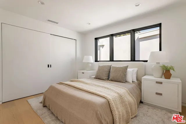 a living room with patio furniture and a potted plant