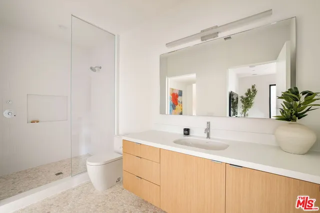 a living room with furniture and a painting on the wall