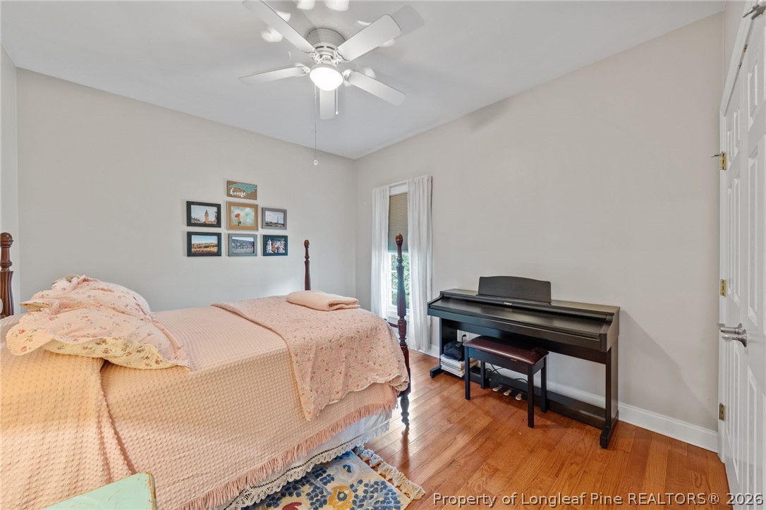 30180 East Lake Road Wagram, NC 28396 - Photo 31 of 42 a bedroom with a bed and a chandelier