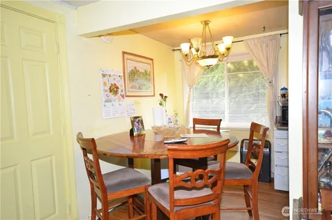 a view of a dining room with furniture and chandelier