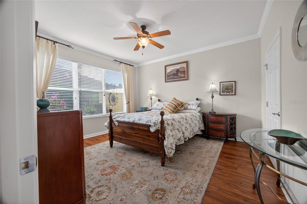 9106 Southwest 65th Loop Ocala, FL 34481 - Photo 11 of 38 a bedroom with a bed and a chandelier