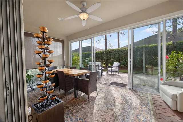 a living room filled with furniture and a floor to ceiling window