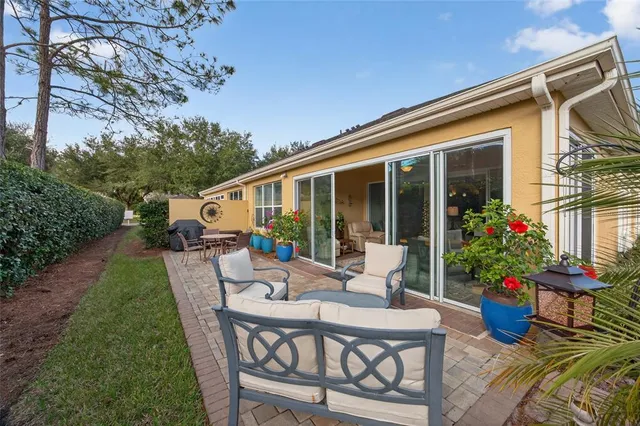 a view of a house with backyard sitting area and garden
