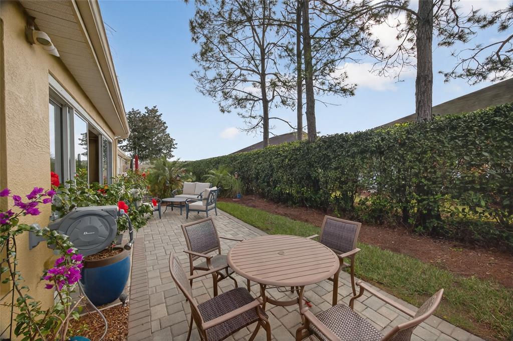 9106 Southwest 65th Loop Ocala, FL 34481 - Photo 18 of 38 a view of a patio with table and chairs and potted plants