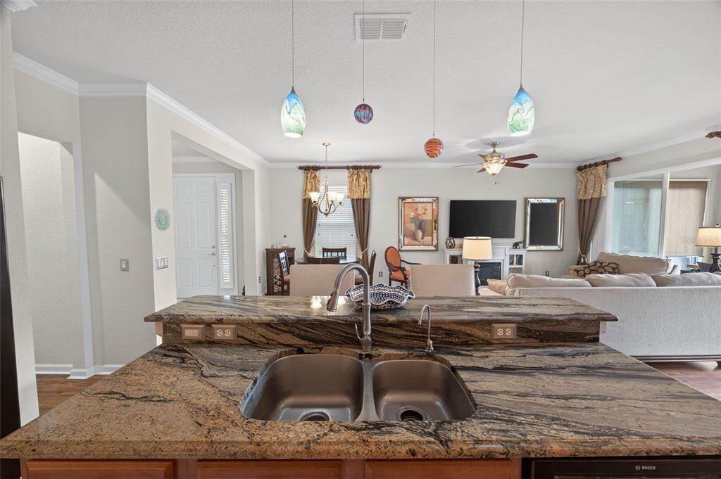 9106 Southwest 65th Loop Ocala, FL 34481 - Photo 10 of 38 a room with furniture and a chandelier