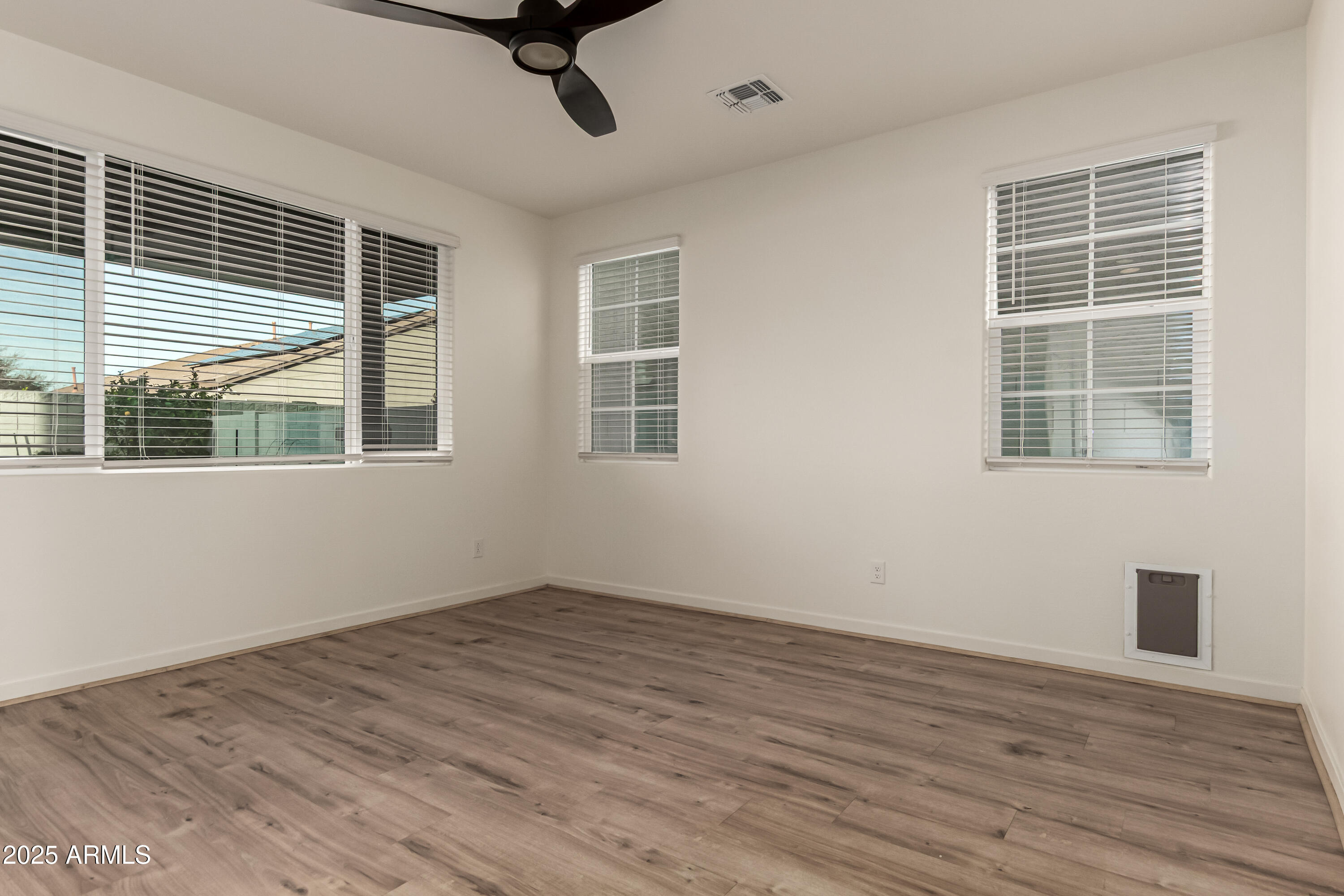 20 East Main Street Mesa, AZ 85201 - Photo 13 of 46 a view of empty room with wooden floor and windows