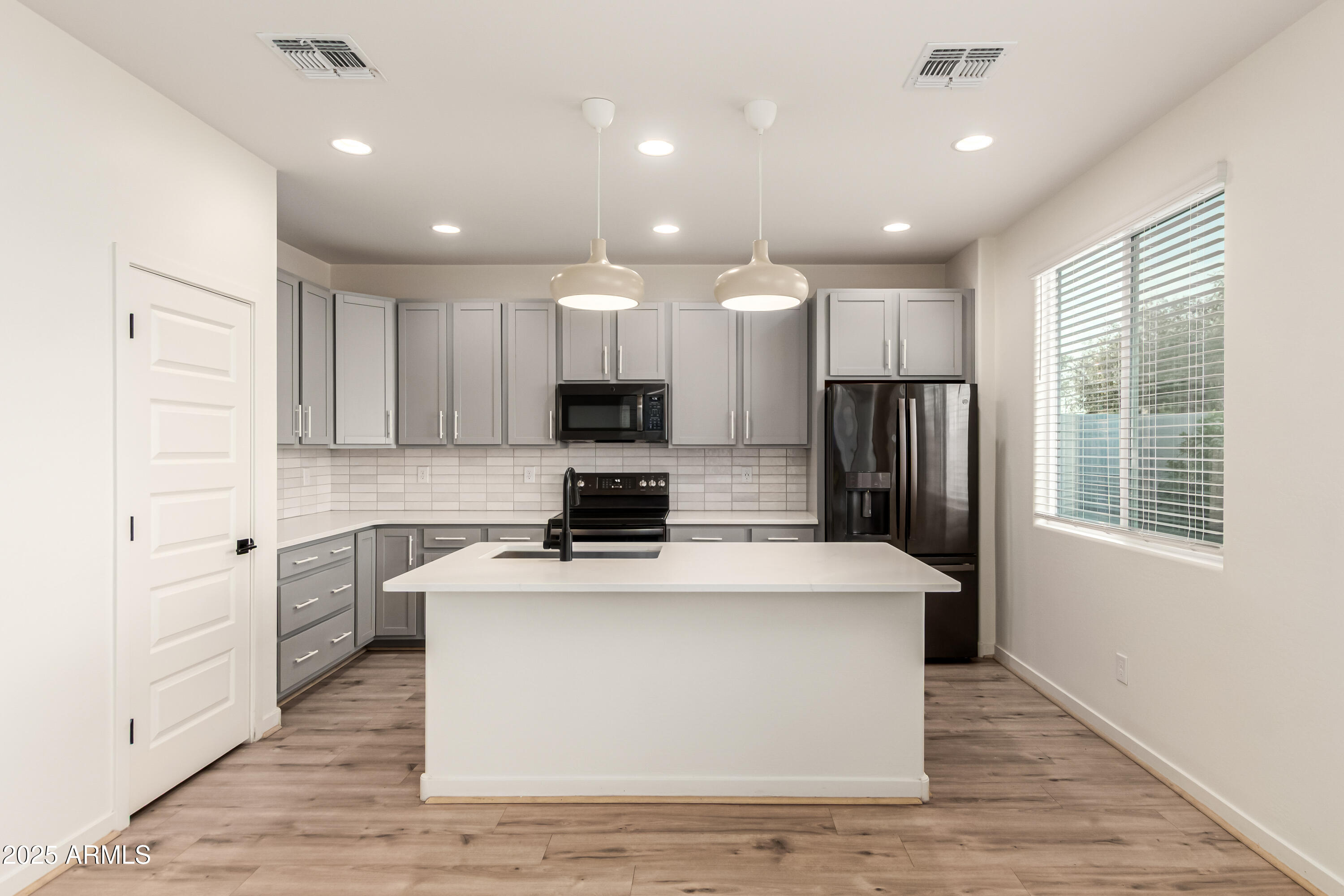 20 East Main Street Mesa, AZ 85201 - Photo 17 of 46 a kitchen with kitchen island a sink stainless steel appliances and window