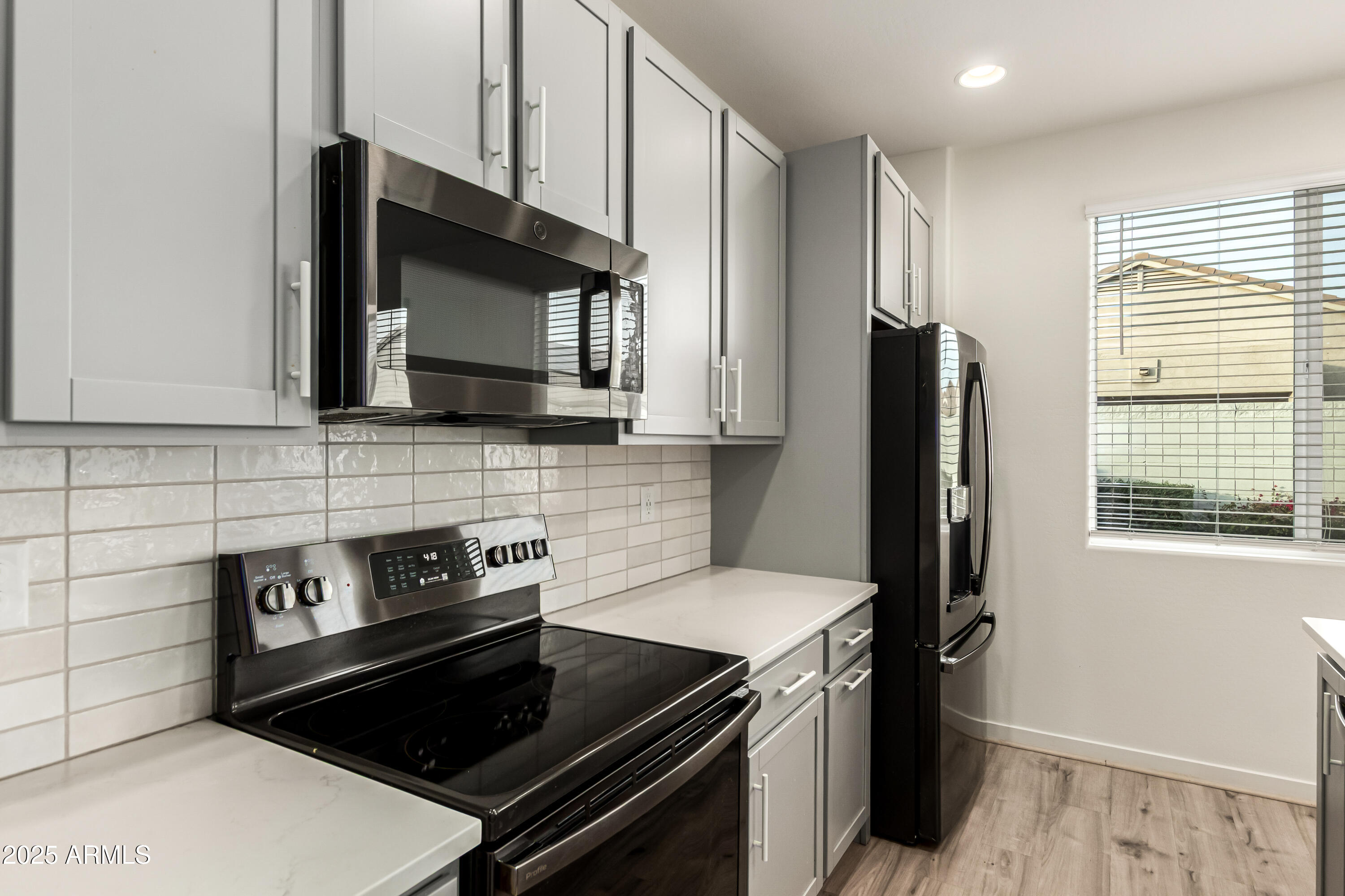20 East Main Street Mesa, AZ 85201 - Photo 20 of 46 a kitchen with a stove and a microwave