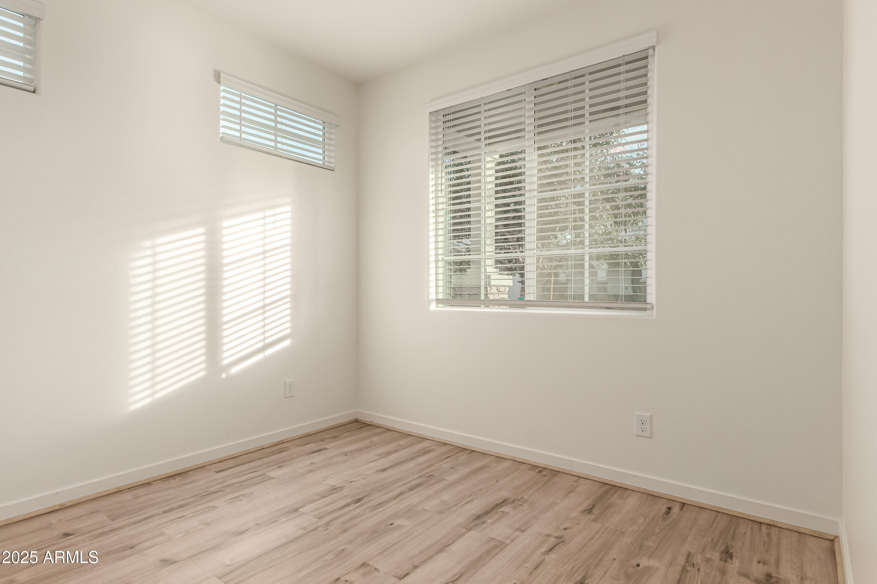 20 East Main Street Mesa, AZ 85201 - Photo 21 of 46 a view of an empty room with wooden floor and a window